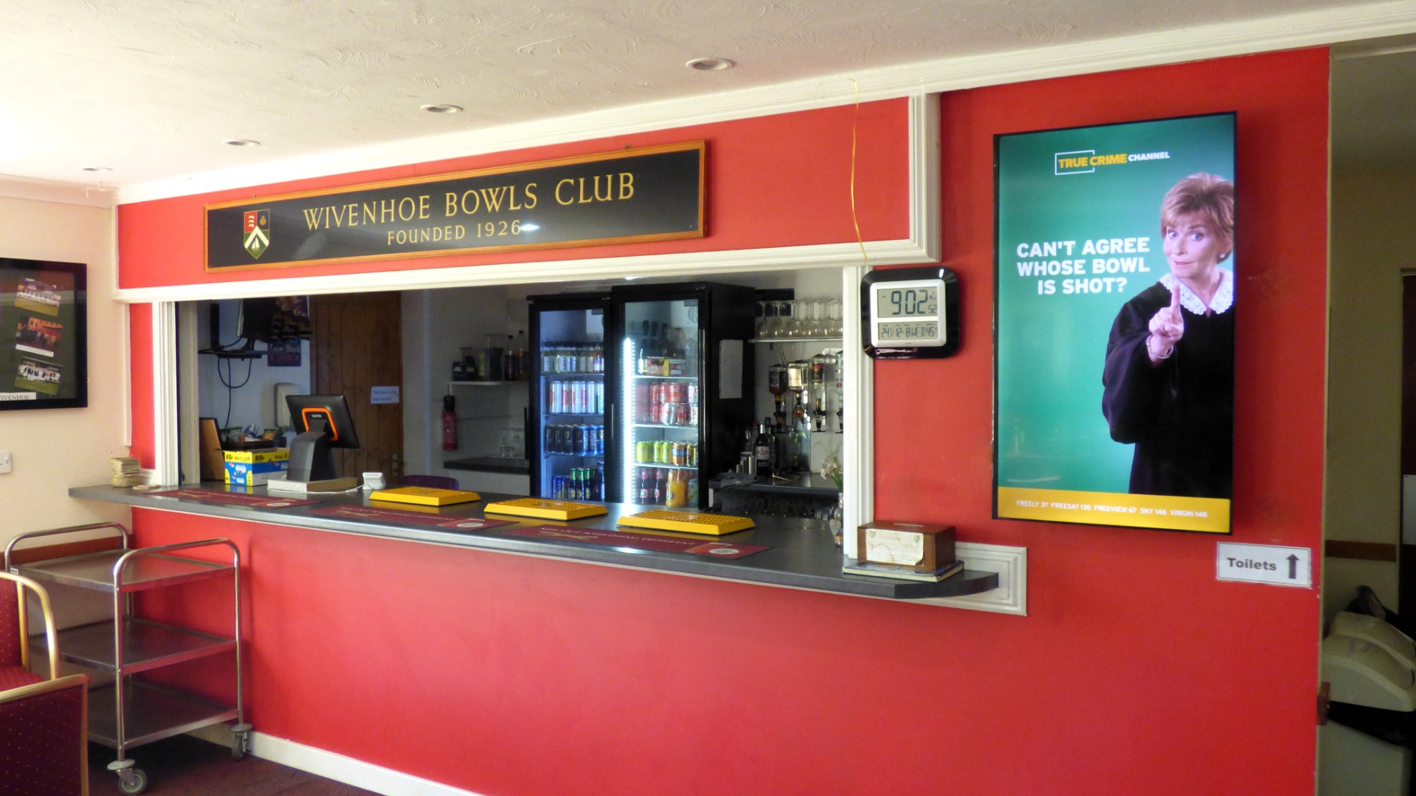 TRUE CRIME Judge Judy campaign on a portrait Grassroot Media screen beside the bar at Wivenhoe Bowls Club.