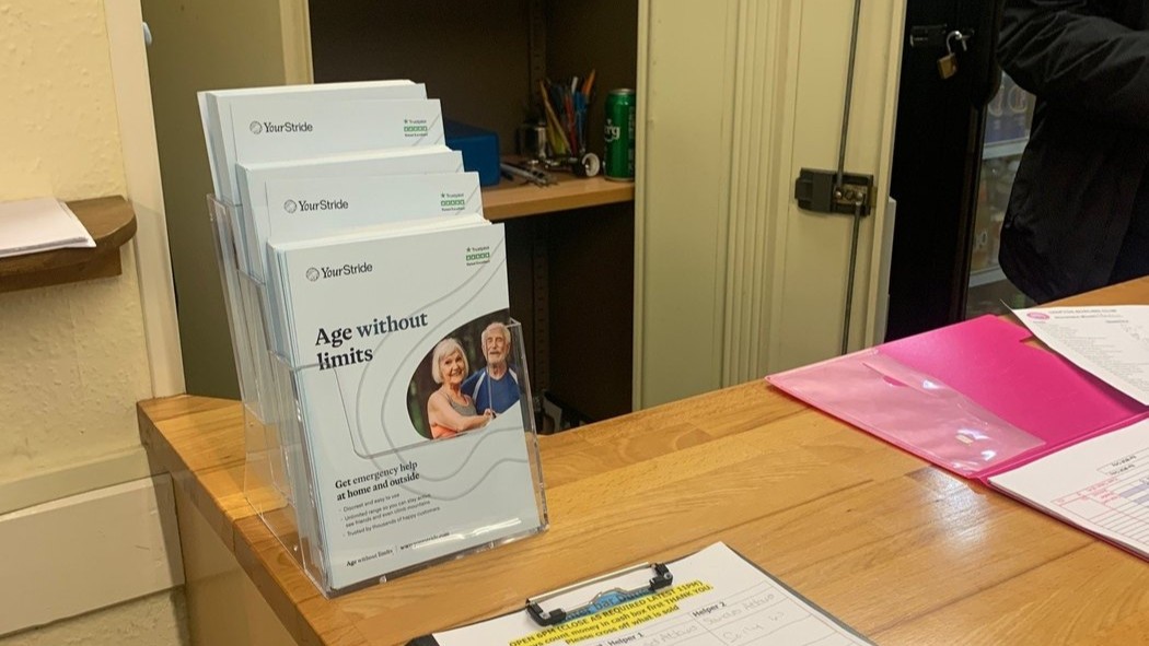 Club information and campaign materials displayed at a clubhouse reception point.