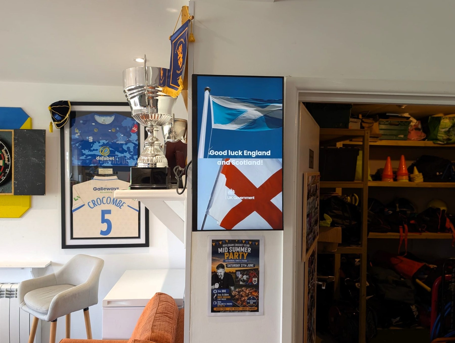 UK Government campaign displayed on a Grassroot Media screen inside a cricket club.
