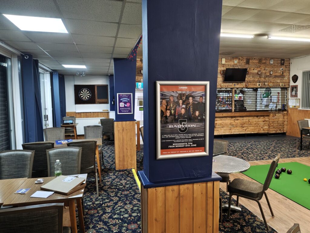 LEGEND television poster for Babylon 5 displayed in the social area of a bowls clubhouse.