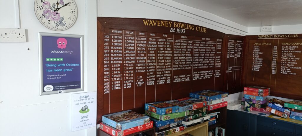 Octopus Energy A3 advertising poster displayed beside the honours board at Waveney Bowling Club.