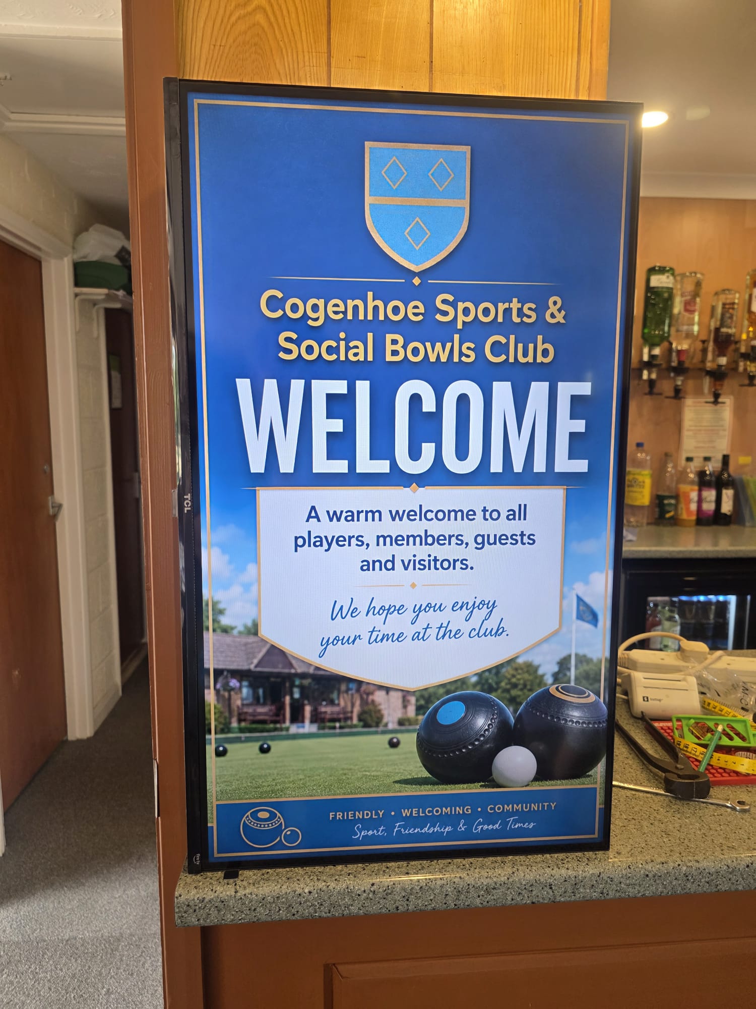 Digital clubhouse screen displaying a welcome message for players members guests and visitors at Cogenhoe Sports and Social Bowls Club