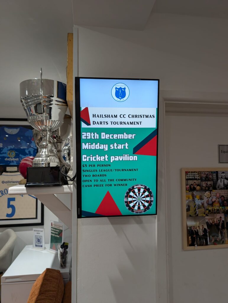 A Grassroot Media portrait digital screen at Hailsham Cricket Club promoting the club Christmas darts tournament