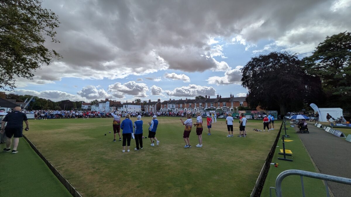 Bowls players and spectators sharing a busy sporting environment during the 2026 National Bowls Finals