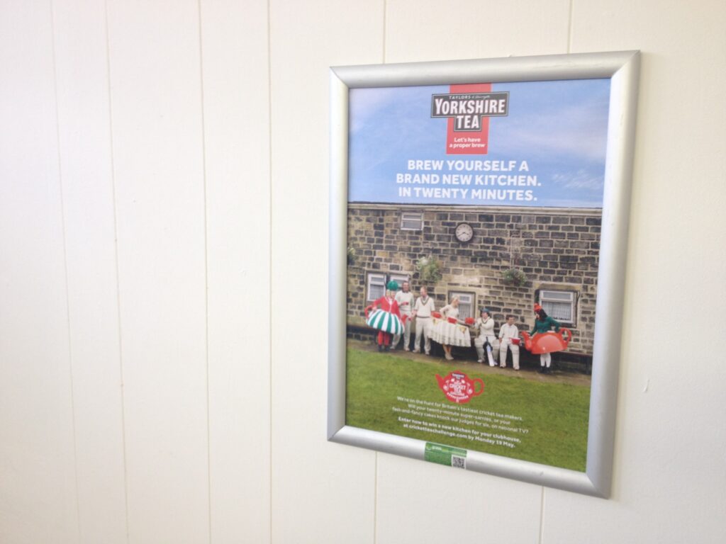 Yorkshire Tea cricket campaign poster mounted inside a grassroots cricket club